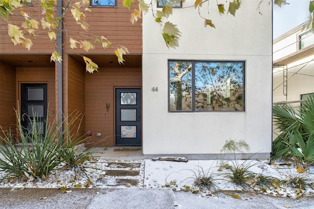 view of snow covered property entrance