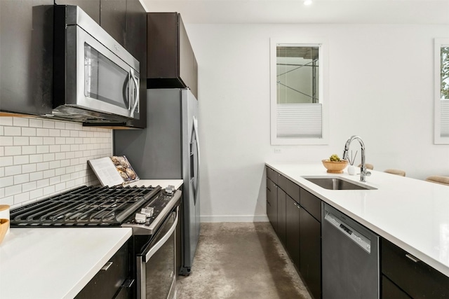 kitchen with appliances with stainless steel finishes, sink, and backsplash