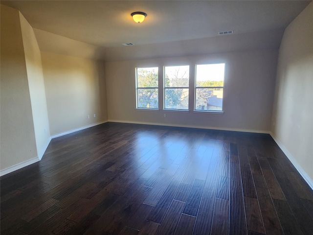 spare room with dark hardwood / wood-style floors