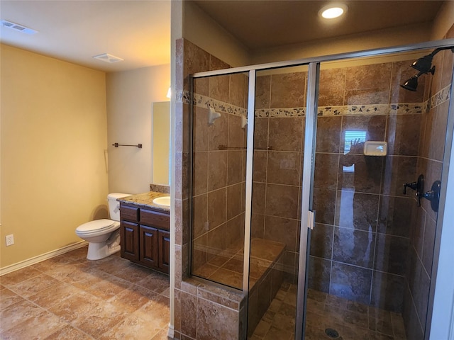 bathroom with vanity, toilet, and a shower with shower door