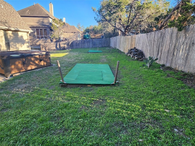 entry to storm shelter featuring a lawn and a hot tub