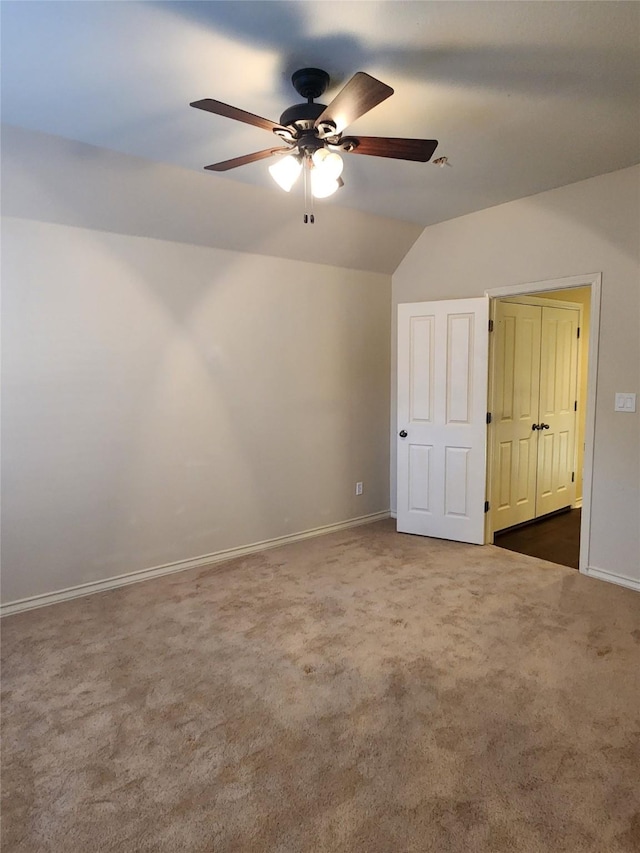 additional living space featuring carpet floors, ceiling fan, and vaulted ceiling