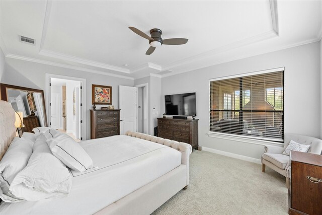 bedroom with ceiling fan, a raised ceiling, crown molding, and light carpet