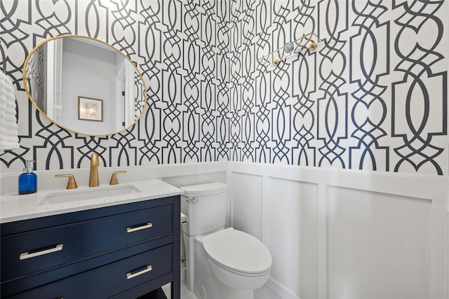 bathroom featuring vanity and toilet