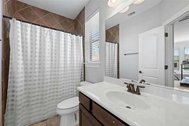 bathroom featuring toilet, tile patterned floors, and vanity