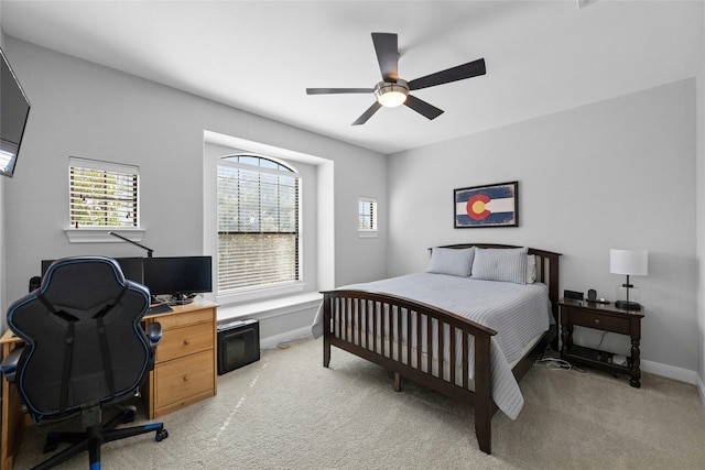 bedroom featuring ceiling fan and light colored carpet