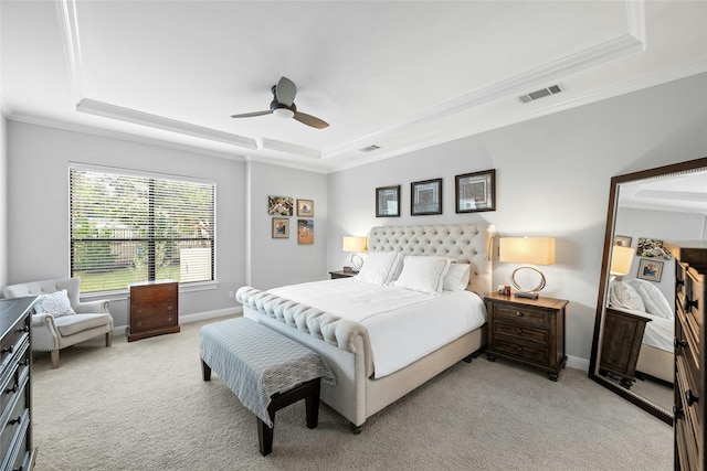 bedroom with ceiling fan, light carpet, ornamental molding, and a raised ceiling