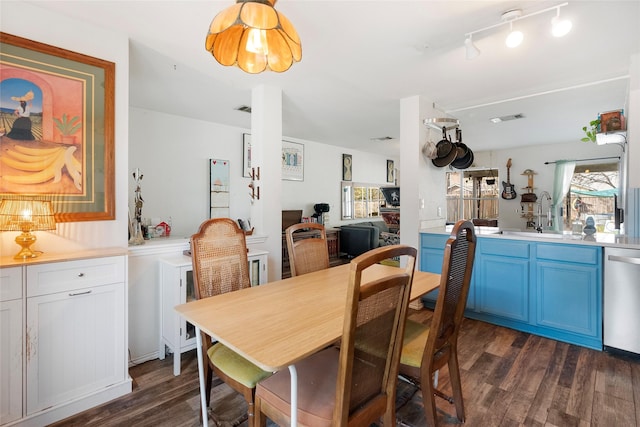 dining room featuring sink and dark hardwood / wood-style floors