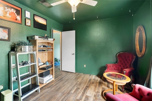 10516 Garbacz Dr, Austin, TX 78748 - living area featuring a textured wall, wood finished floors, and ceiling fan