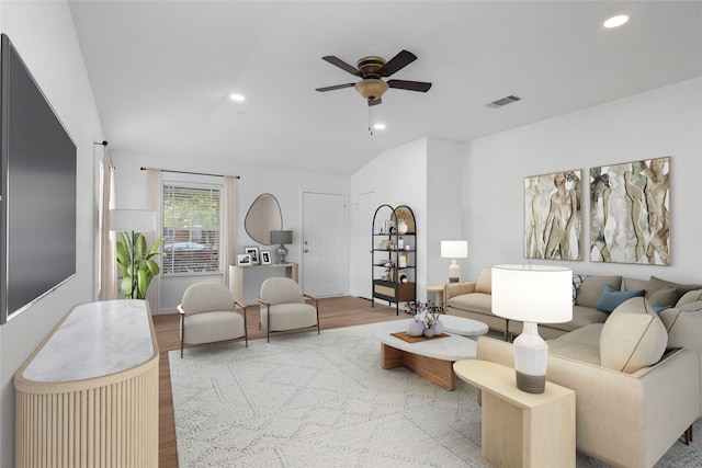 living room with lofted ceiling, light hardwood / wood-style floors, and ceiling fan