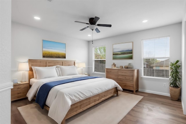 bedroom with dark hardwood / wood-style floors and ceiling fan