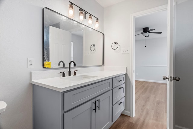 bathroom with vanity, hardwood / wood-style flooring, and ceiling fan