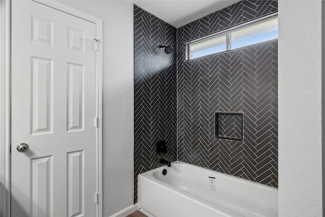 bathroom featuring tiled shower / bath