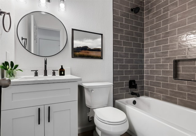 full bathroom featuring vanity, toilet, and tiled shower / bath