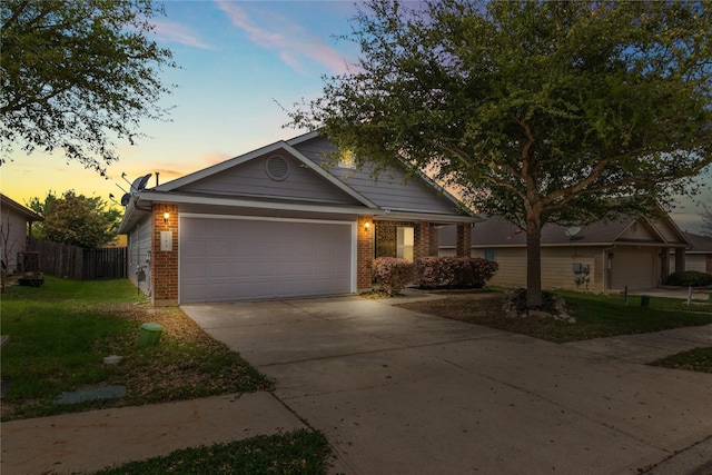 view of front of property with a garage and a yard