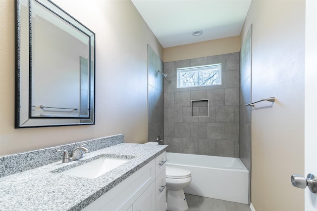 full bathroom featuring tiled shower / bath combo, vanity, and toilet