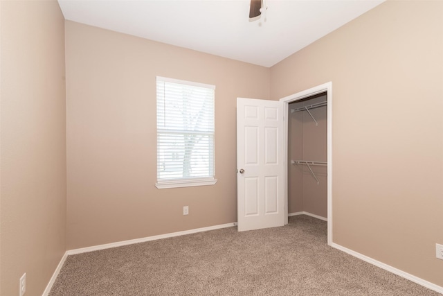 unfurnished bedroom featuring a closet, ceiling fan, and carpet