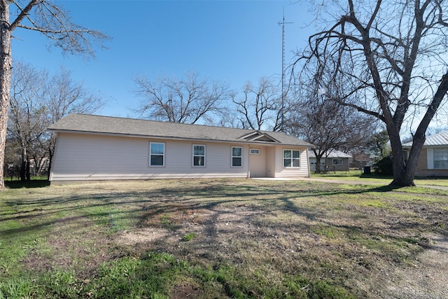 back of property featuring a yard