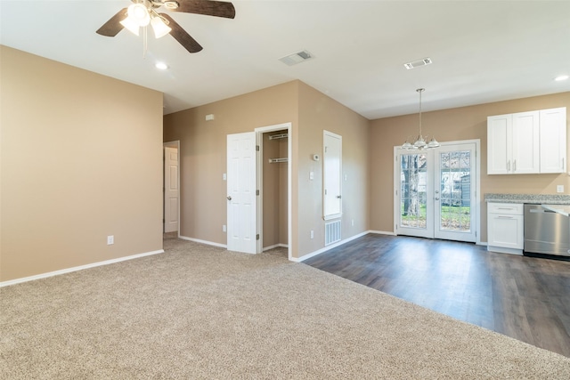 kitchen featuring dishwasher, ceiling fan, hanging light fixtures, white cabinets, and dark colored carpet