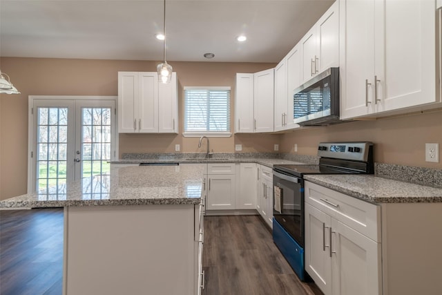 kitchen featuring white cabinets, range with electric cooktop, and dark hardwood / wood-style floors