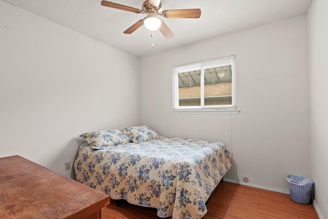 bedroom featuring ceiling fan and hardwood / wood-style flooring