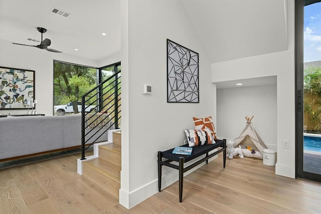 stairway featuring hardwood / wood-style floors and ceiling fan