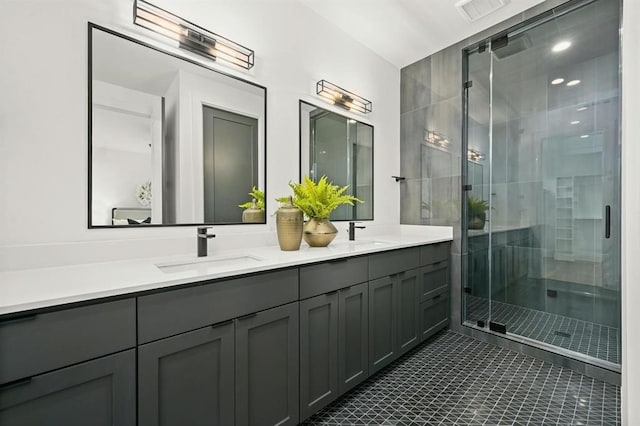 bathroom with an enclosed shower, vanity, and tile patterned flooring