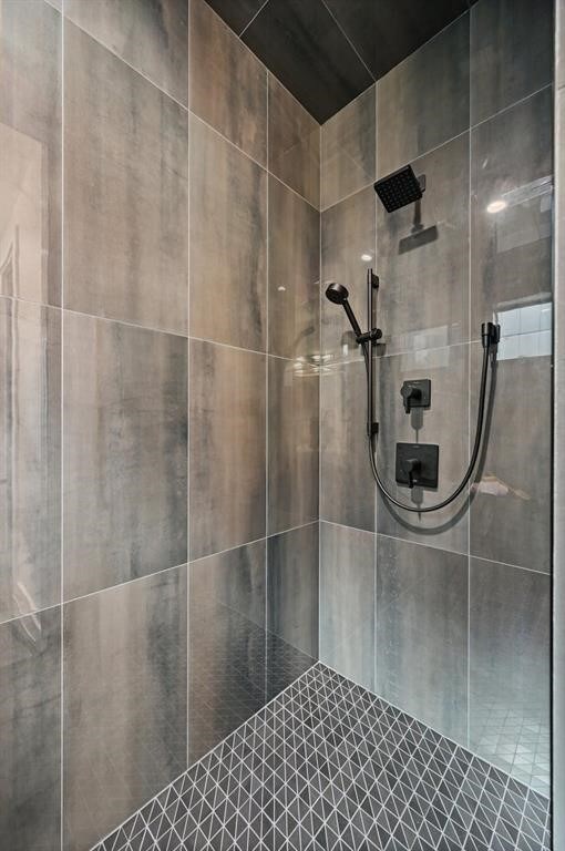 bathroom with tiled shower