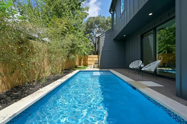 view of swimming pool with a patio