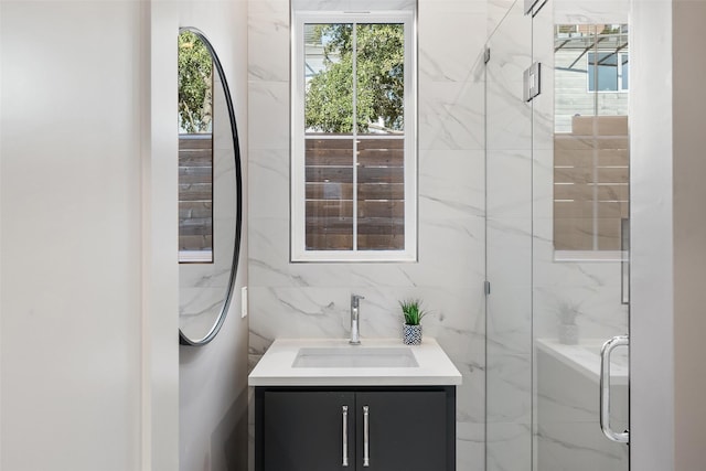 bathroom featuring a stall shower, tile walls, and vanity