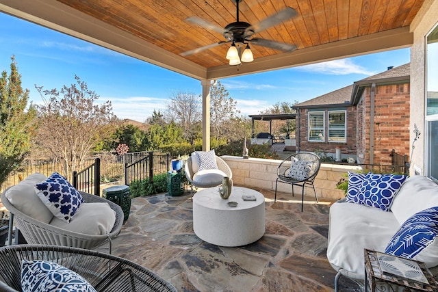 view of patio with an outdoor living space and ceiling fan