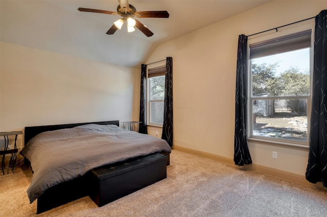 bedroom with ceiling fan, light colored carpet, and vaulted ceiling