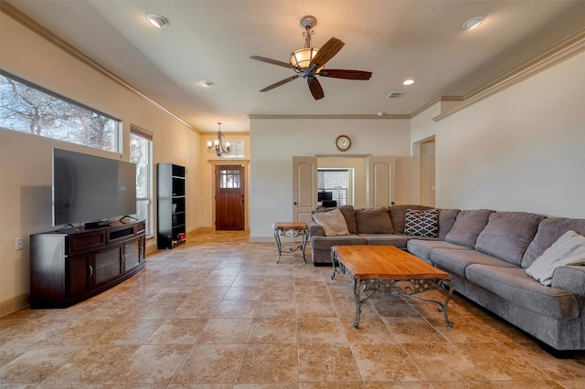 living room with ceiling fan with notable chandelier and ornamental molding