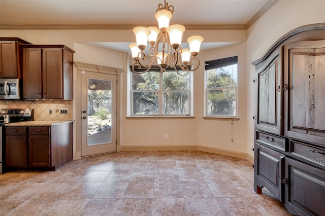 kitchen with hanging light fixtures, tasteful backsplash, light stone countertops, ornamental molding, and stainless steel appliances