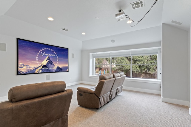 cinema room with vaulted ceiling and carpet flooring