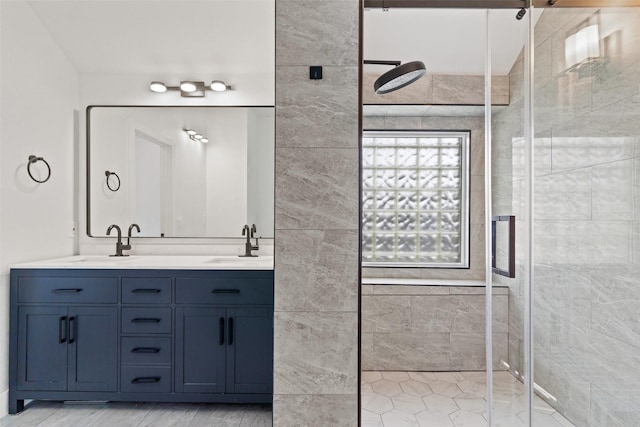 bathroom with vanity and a shower with door