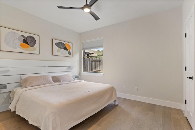 bedroom with ceiling fan and wood-type flooring