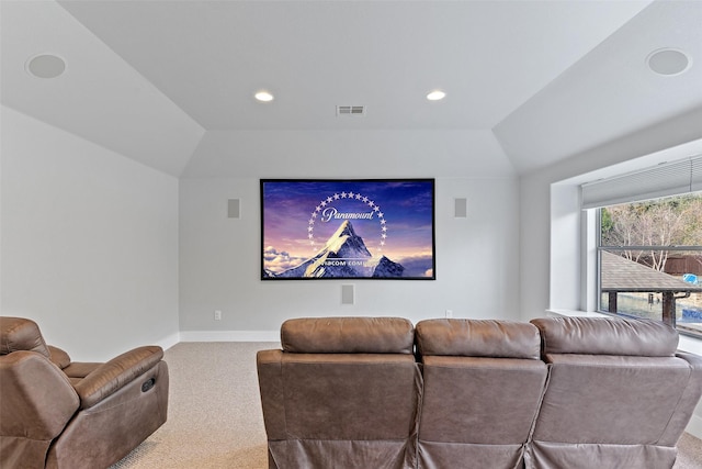 carpeted home theater featuring lofted ceiling