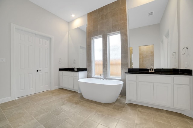 17604 Arend Path, Pflugerville, TX 78660 - full bathroom with a soaking tub and two vanities