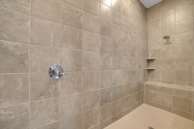 bathroom with a tile shower