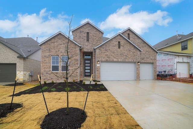 17604 Arend Path, Pflugerville, TX 78660 - view of front of house with brick siding, concrete driveway, and a garage