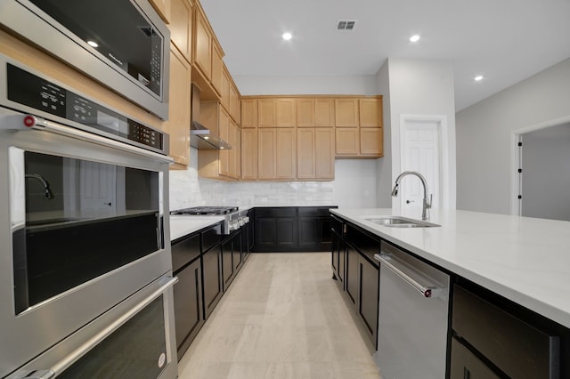 kitchen featuring tasteful backsplash, sink, stainless steel appliances, and light brown cabinets