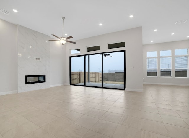 17604 Arend Path, Pflugerville, TX 78660 - unfurnished living room featuring a ceiling fan, plenty of natural light, recessed lighting, a fireplace, and light tile patterned flooring