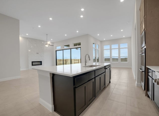 17604 Arend Path, Pflugerville, TX 78660 - kitchen with a sink, light countertops, open floor plan, recessed lighting, and a center island with sink