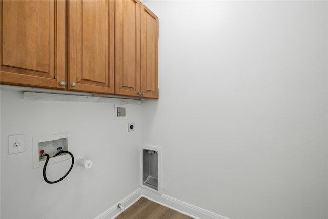 washroom featuring washer hookup, gas dryer hookup, electric dryer hookup, and cabinets