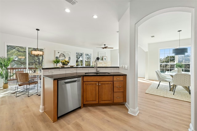 kitchen featuring sink, pendant lighting, light hardwood / wood-style flooring, and dishwasher