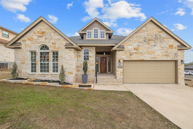 view of front of property with a garage and a front lawn