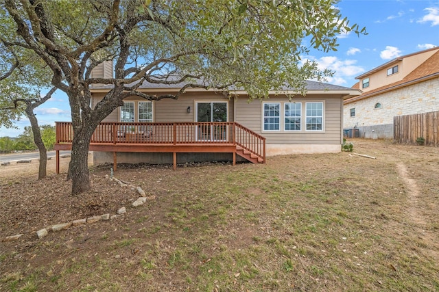 back of house with a yard and a deck