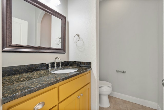 bathroom featuring tile patterned floors, toilet, and vanity