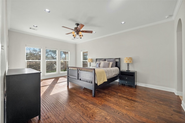 bedroom featuring ornamental molding, dark hardwood / wood-style floors, and ceiling fan